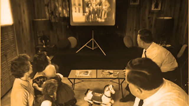 Slide projector showing 35mm family memories on screen