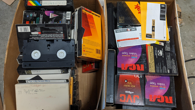 Old VHS tapes in a box needing to be digitized