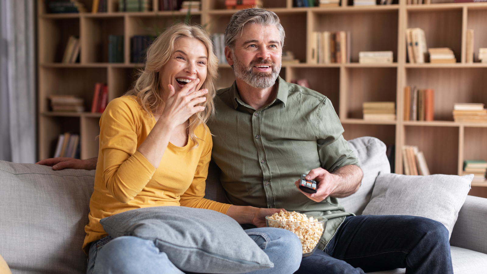 Couple celebrating 30 year anniversary watching digitized wedding video
