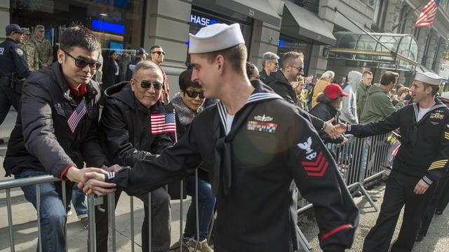 US Navy servicemember being thanked for their service during a community event
