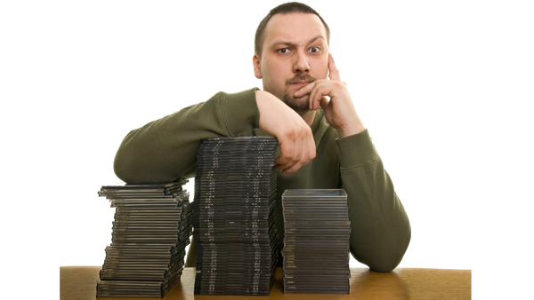 Man With Stacks of CD, DVD, and Blu-ray Discs