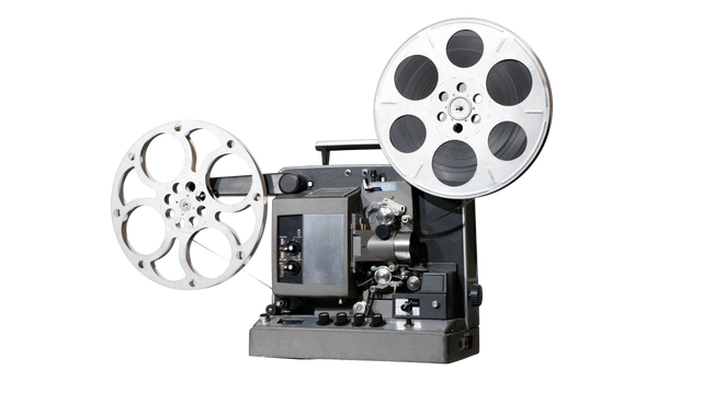 Vintage 16mm film projector playing a movie reel