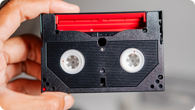 Man holding an 8mm tape to be converted to digital