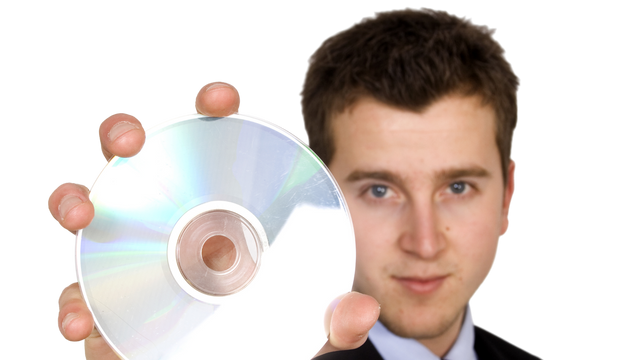 Man holding a DVD to be converted to digital