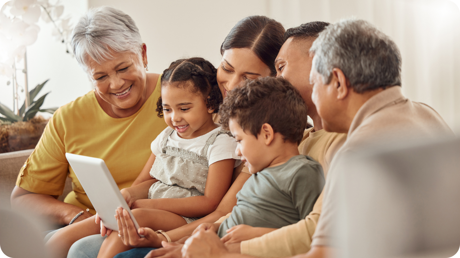 family viewing digitized photos together on tablet