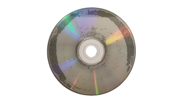 Close view of DVD rot showing delamination and pinholes that make discs unreadable