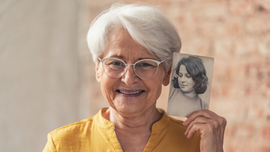 Elder Woman Holding Old Photo of Herself