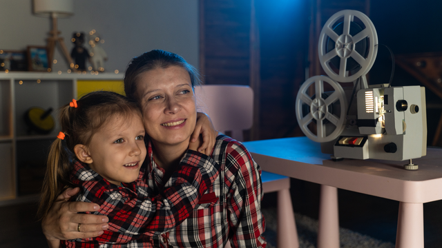 Family enjoying home movies together on screen
