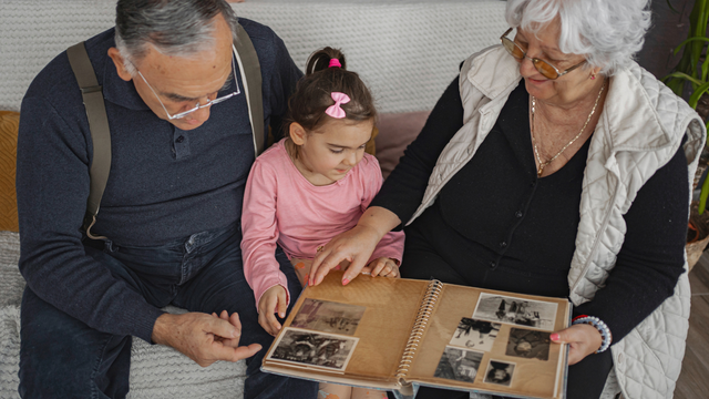 Family using a photo scanning service to digitize photos from old albums
