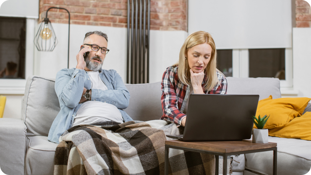 Frustrated married couple on hold with Legacybox while writing a negative Google review