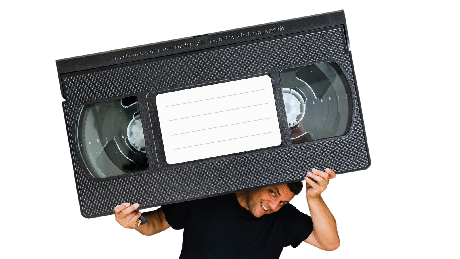 Man Burdened By an Oversize VHS Cassette Tape