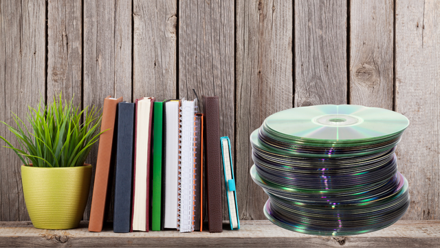 Stack of old DVDs ready for disc to digital conversion