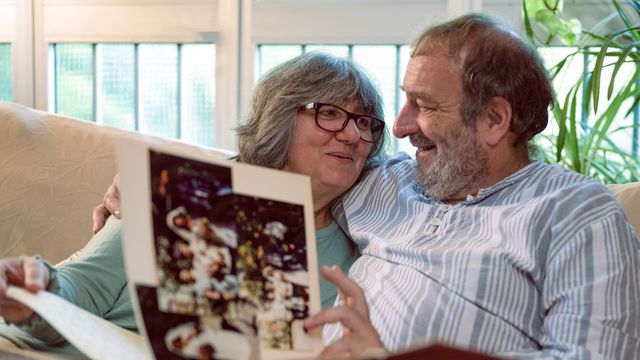 family looking at old printed photographs together