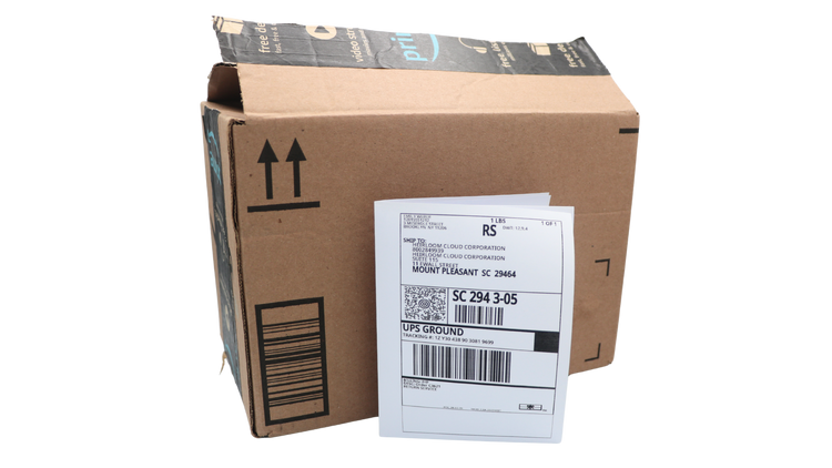 Heirloom prepaid shipping label beside a shipping box